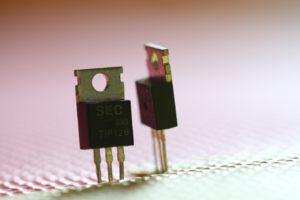 a photograph of two transistors standing on end in a bright scene