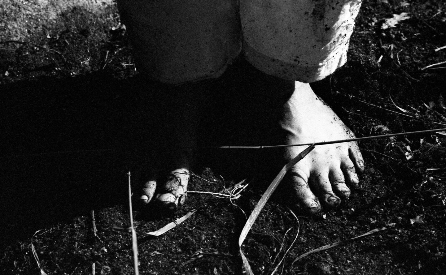 bare feet of pilgrim in muddy soil